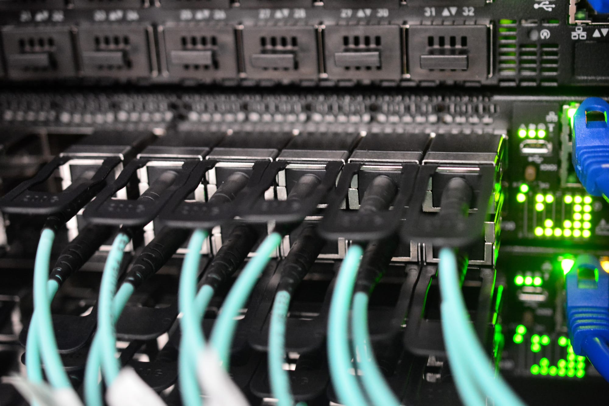 High-speed network cables connected to computing infrastructure in a data center.